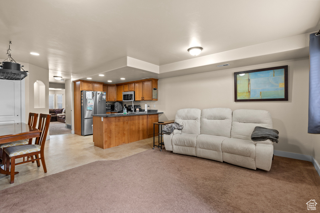 Living area with recessed lighting and light carpet