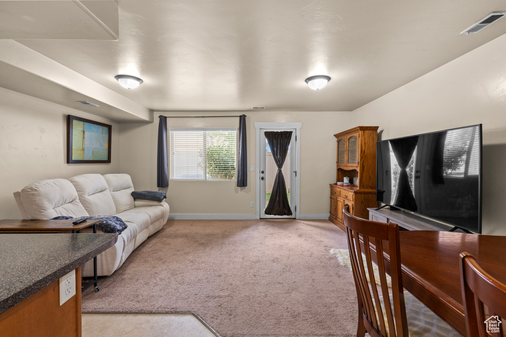 Living room featuring light carpet and baseboards