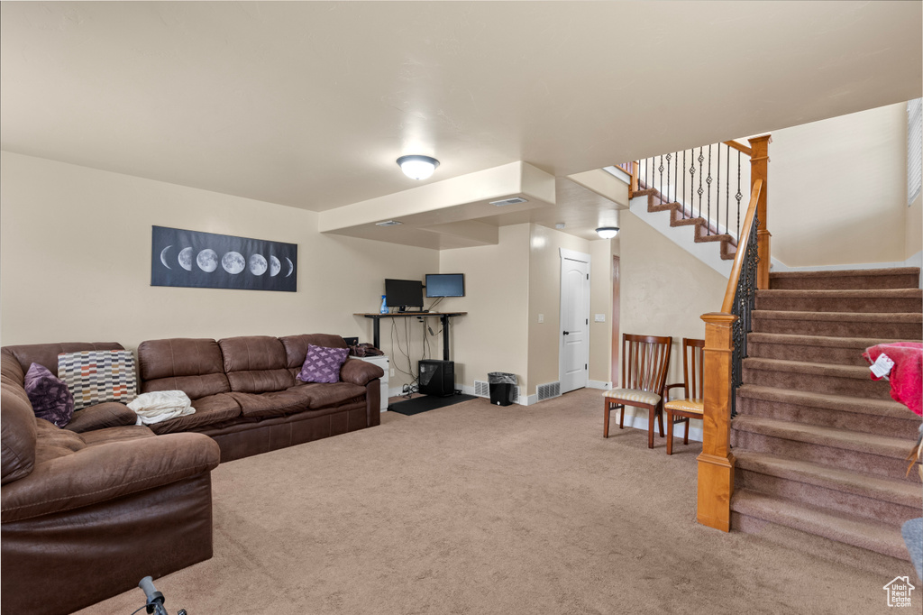 Living area with carpet flooring and stairs