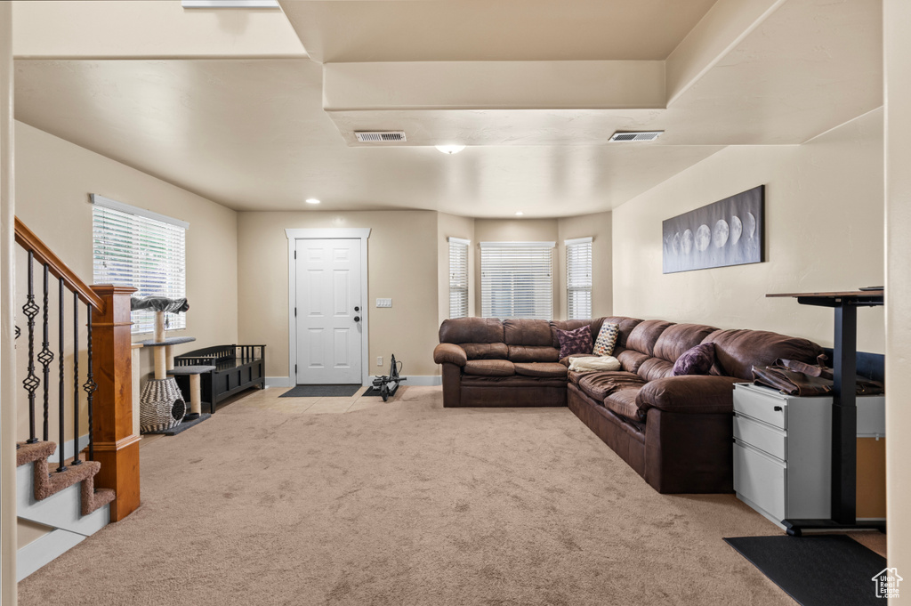 Living area featuring carpet and stairway