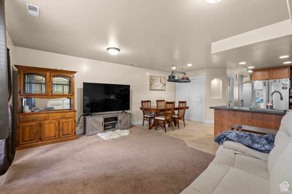 Living room with light carpet and recessed lighting