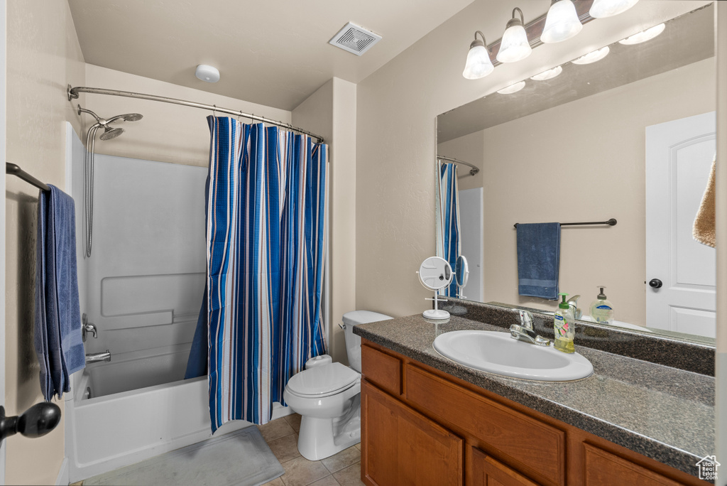 Full bath featuring vanity, tile patterned floors, and shower / bathtub combination with curtain