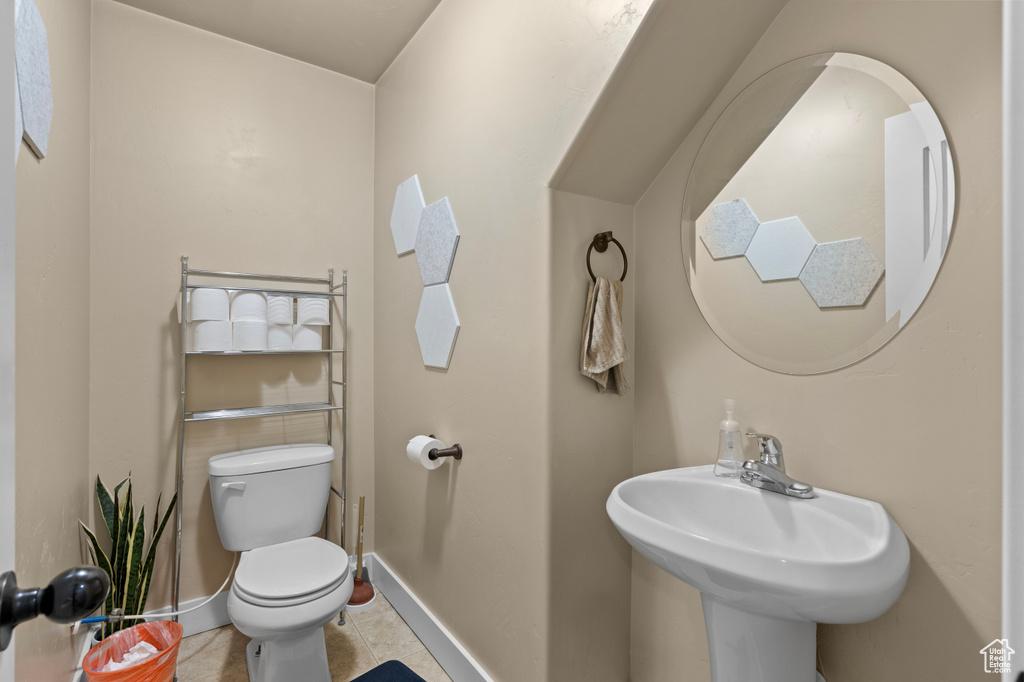 Bathroom with toilet and tile patterned floors