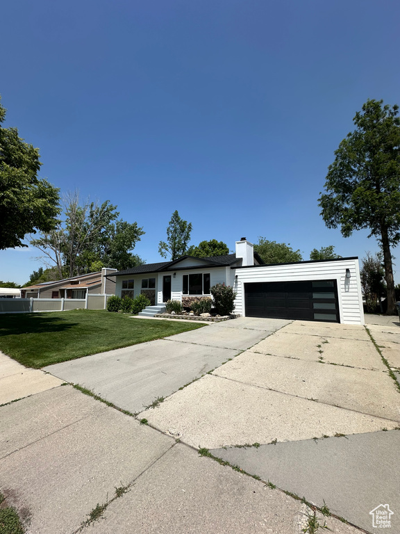 View of front of property featuring a front yard and a chimney