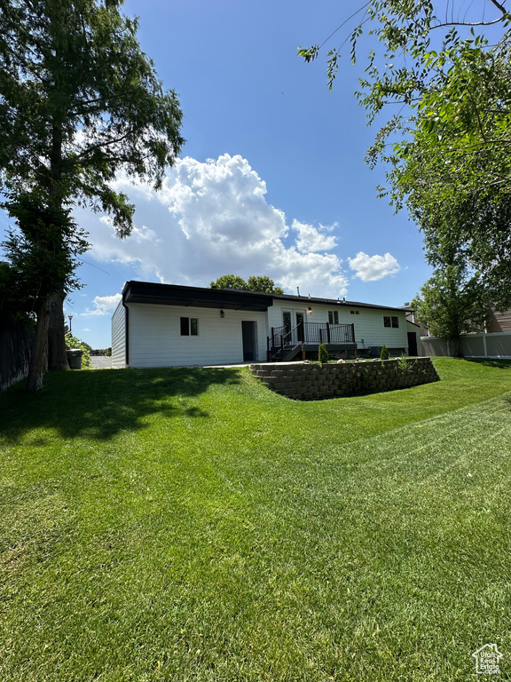 Back of house featuring a wooden deck