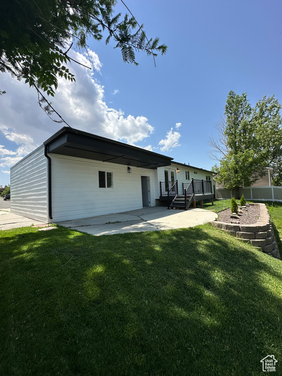Back of property featuring a patio and a deck