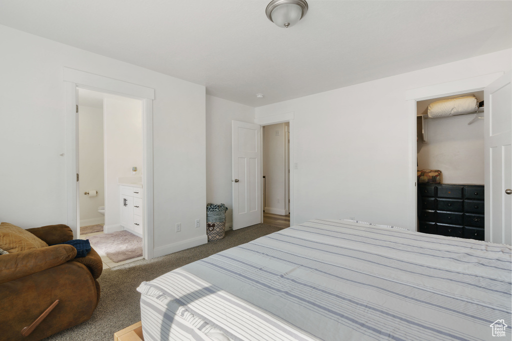 Bedroom with baseboards, carpet, and ensuite bathroom