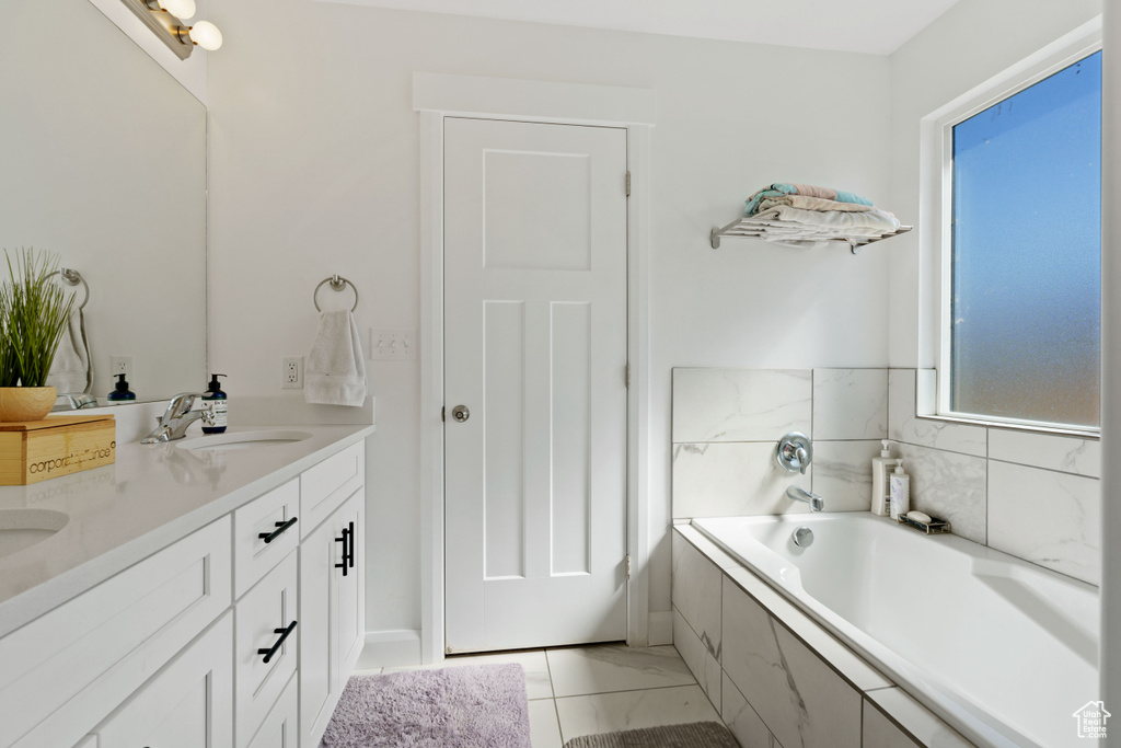 Full bathroom with double vanity and a garden tub