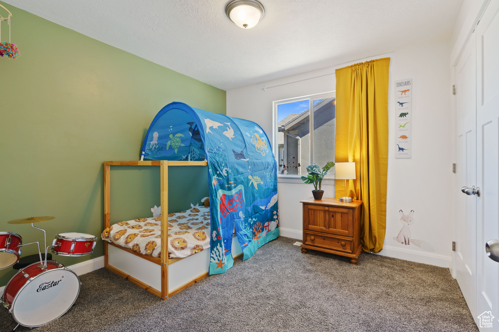 Carpeted bedroom featuring baseboards