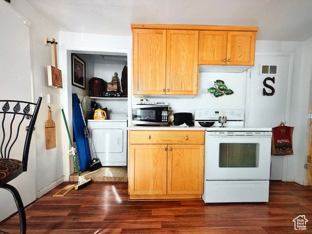 Kitchen with white range with electric cooktop, washer / dryer, stainless steel microwave, and dark wood-type flooring