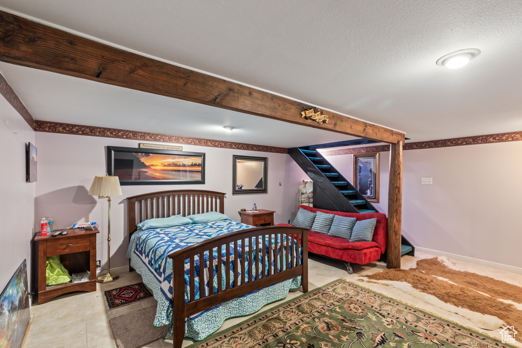 Bedroom with baseboards and a textured ceiling