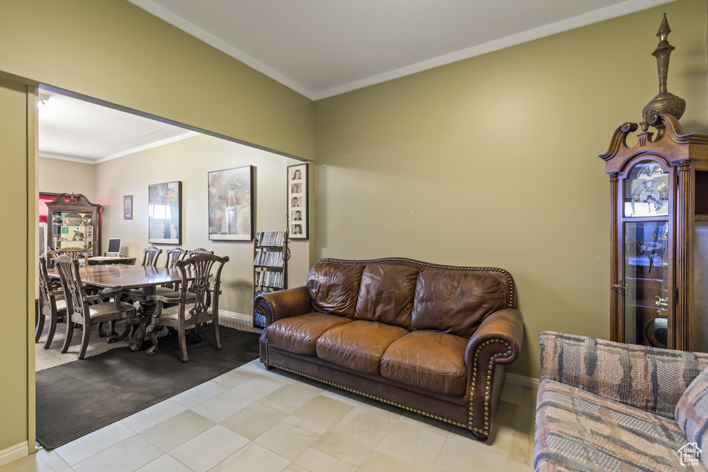 Tiled living room featuring ornamental molding and carpet floors