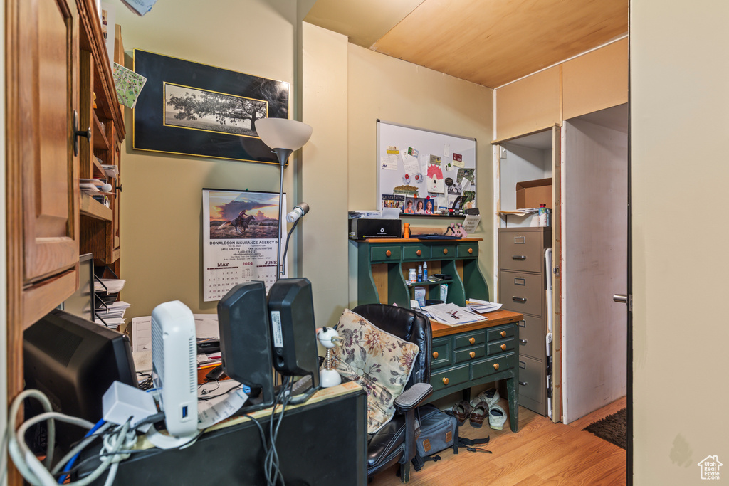 Office with light wood-style floors