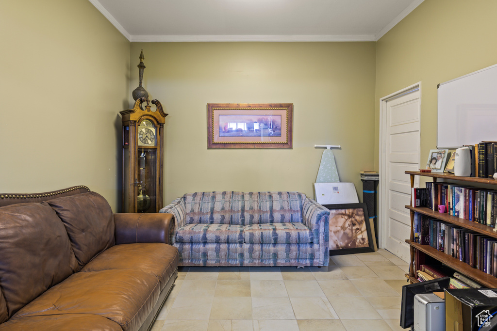 Living area featuring ornamental molding and light tile patterned floors