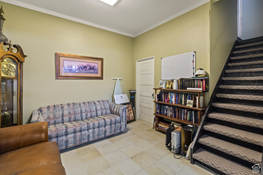 Living room with stairs and crown molding