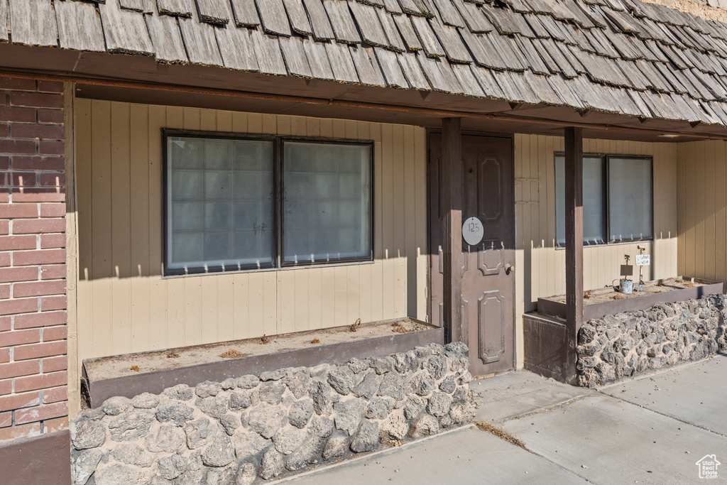 Doorway to property featuring brick siding