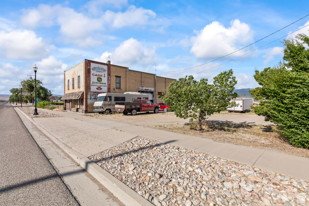 View of asphalt street with street lights, sidewalks, and curbs