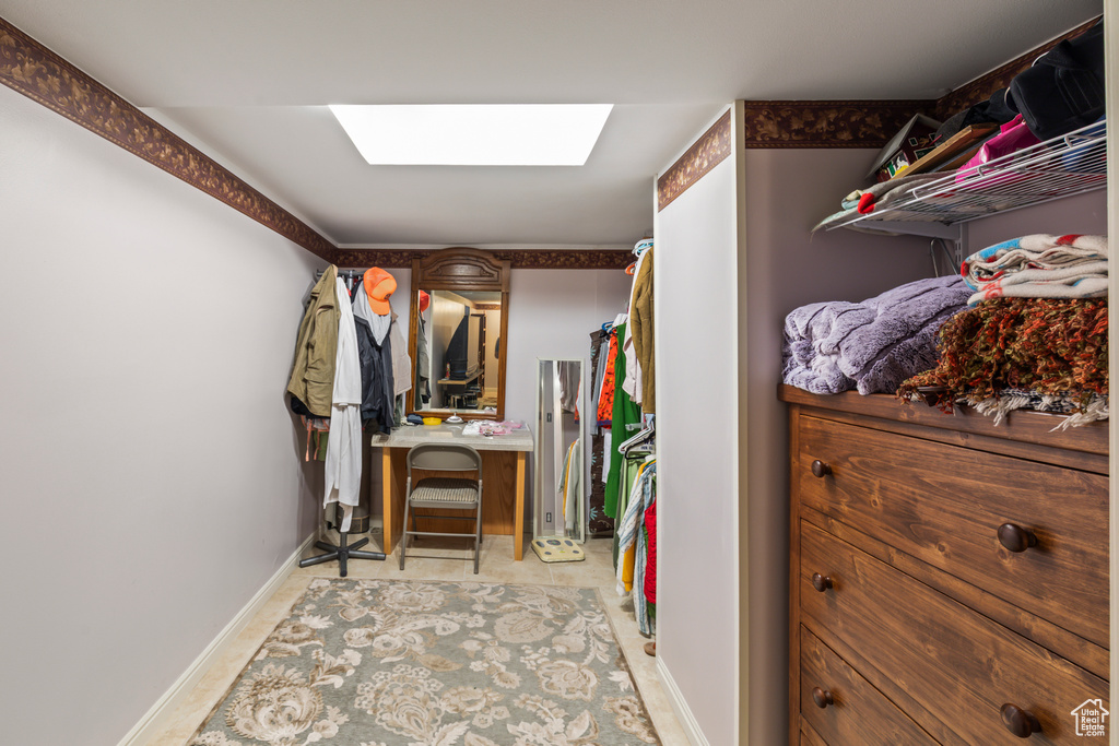 Spacious closet featuring a skylight