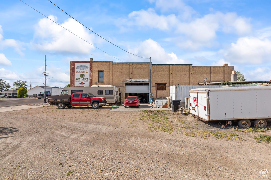 View of building exterior with uncovered parking