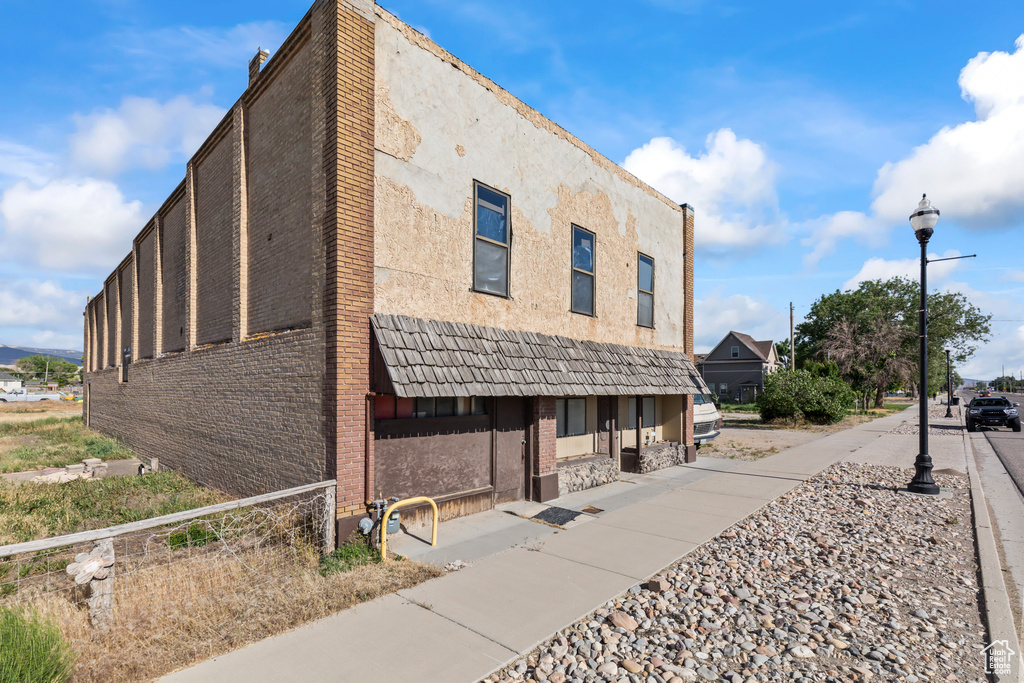 View of side of property featuring brick siding