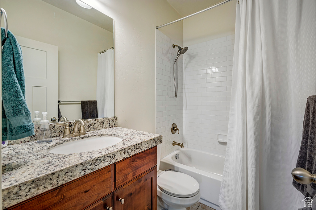 Full bathroom featuring vanity and shower / bath combo with shower curtain