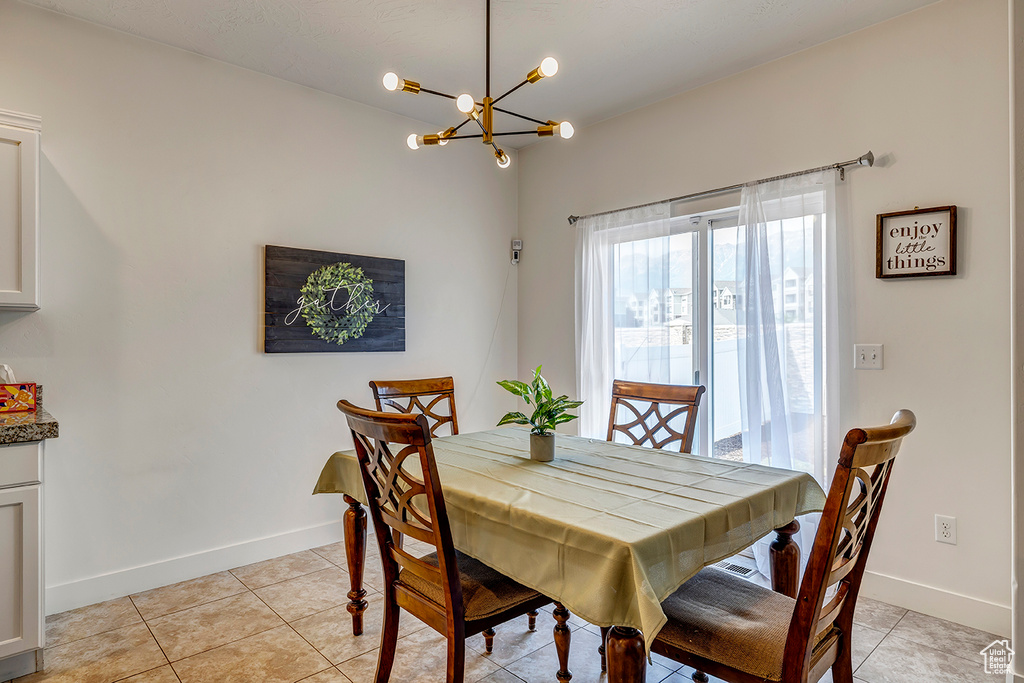 Dining area featuring a chandelier and light tile patterned floors