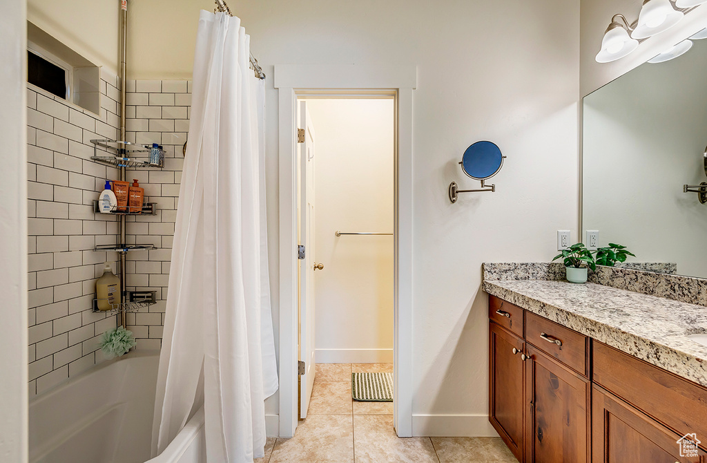 Full bath featuring vanity, shower / bath combination with curtain, and tile patterned floors