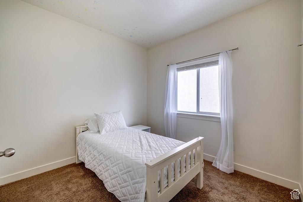 Carpeted bedroom with baseboards