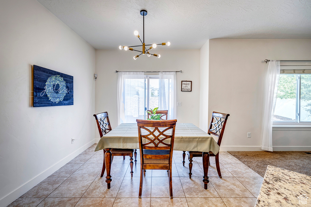 Dining space with a chandelier and light tile patterned floors