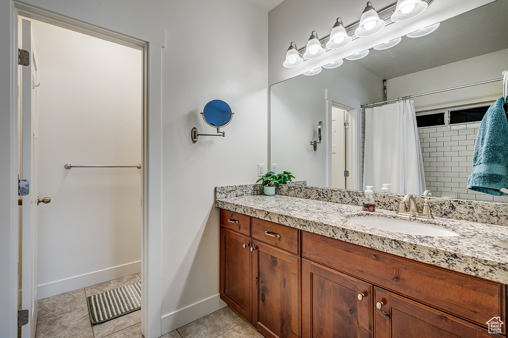 Bathroom featuring vanity, tile patterned floors, and a shower with curtain