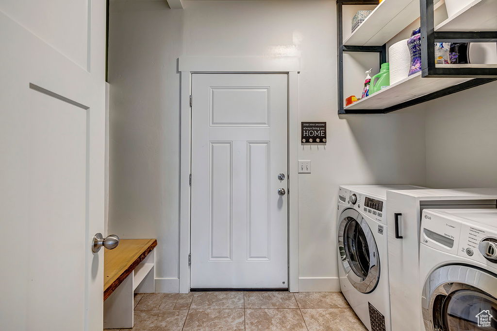 Laundry room with washer and dryer and baseboards