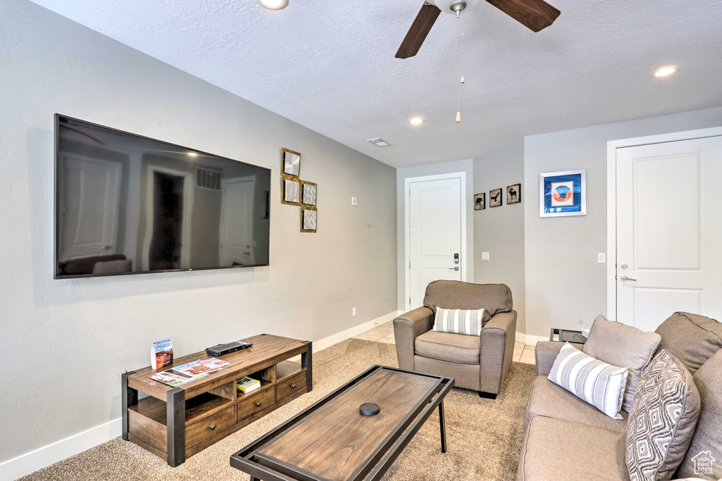 Living room featuring baseboards, ceiling fan, carpet floors, recessed lighting, and a textured ceiling