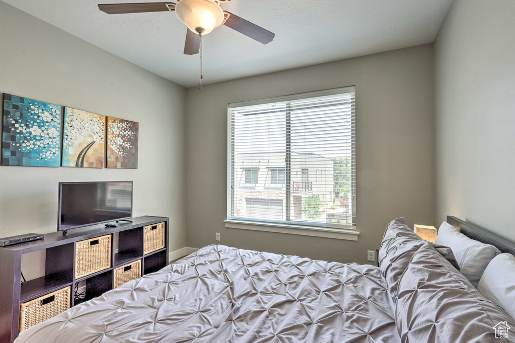 Bedroom featuring multiple windows and a ceiling fan