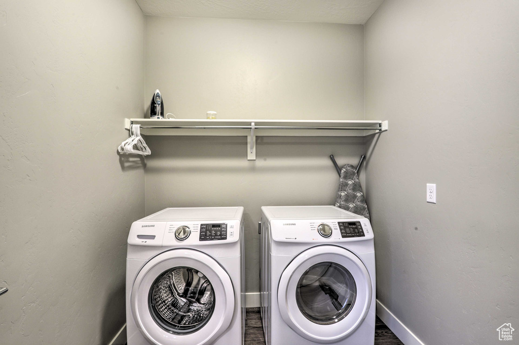 Laundry area featuring washer and clothes dryer and baseboards
