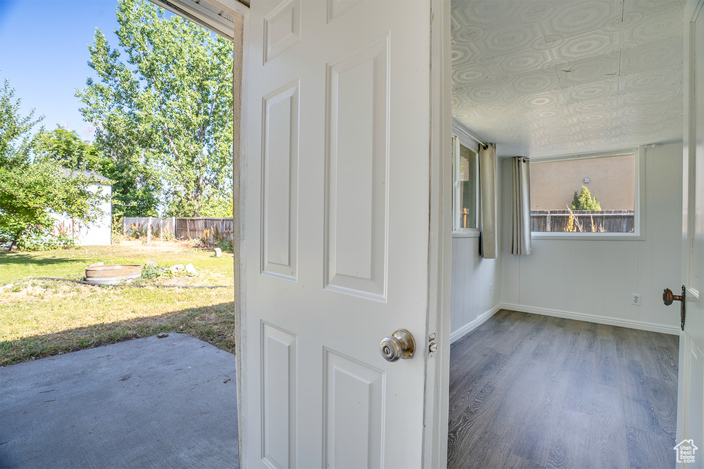 Spare room featuring baseboards and wood finished floors