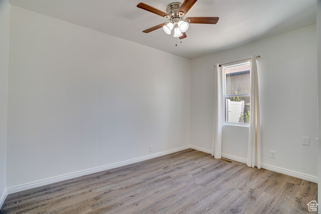 Spare room with light wood-style flooring and a ceiling fan