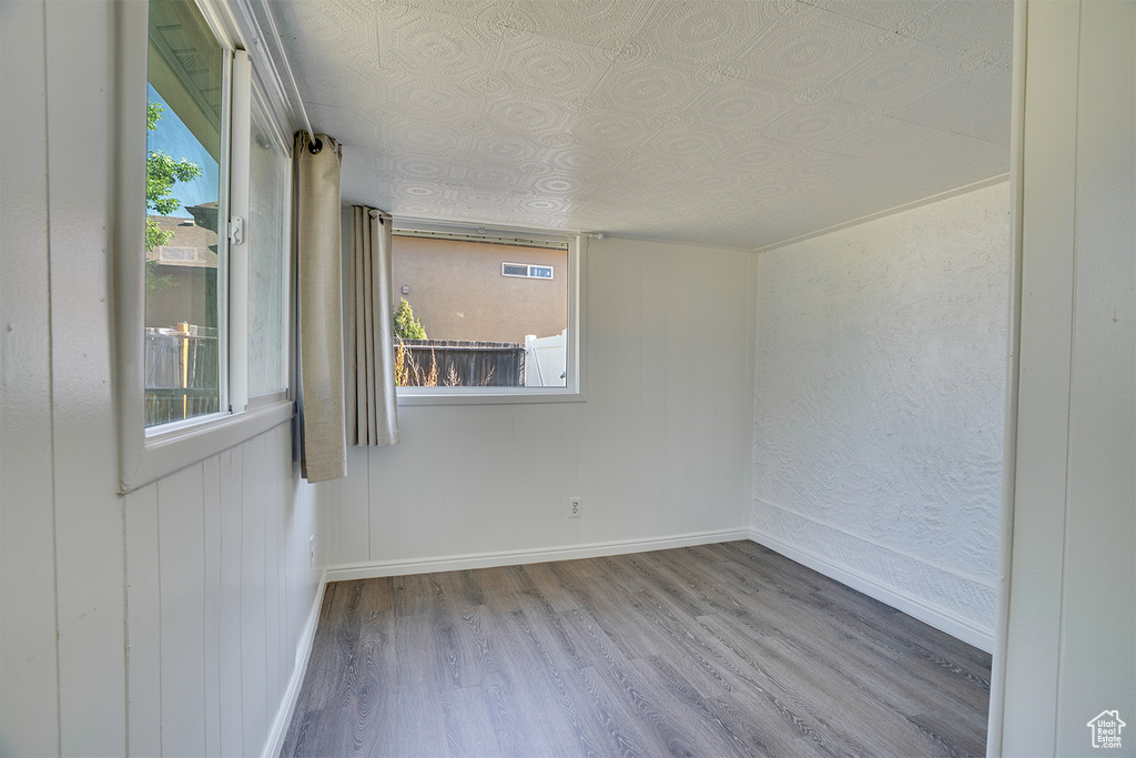 Unfurnished room featuring wood finished floors and an ornate ceiling
