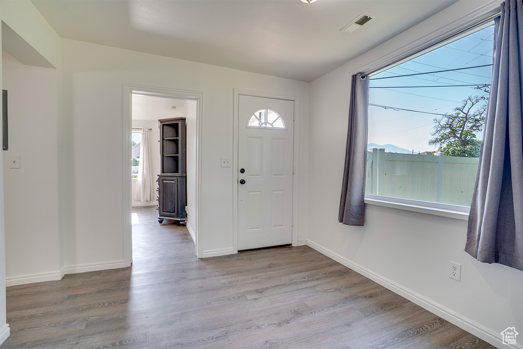 Foyer entrance featuring wood finished floors and baseboards