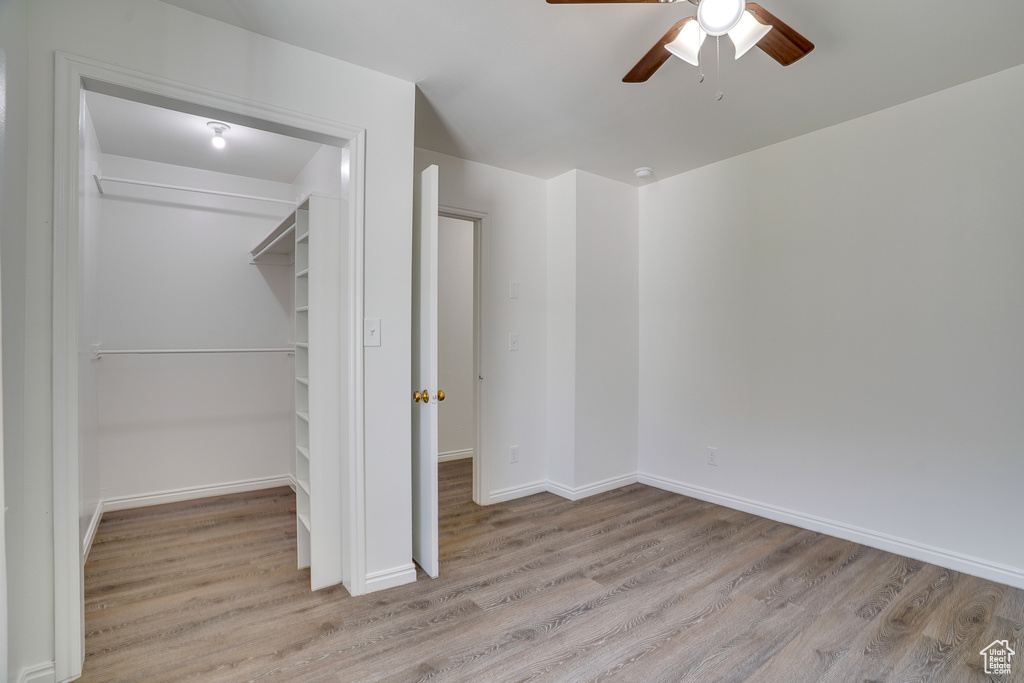 Unfurnished bedroom with wood finished floors and ceiling fan