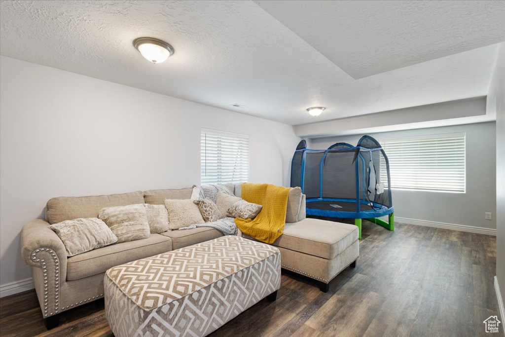 Living room with wood finished floors and a textured ceiling