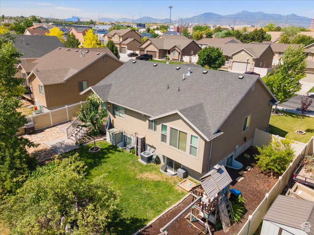 Aerial perspective of suburban area featuring a mountainous background