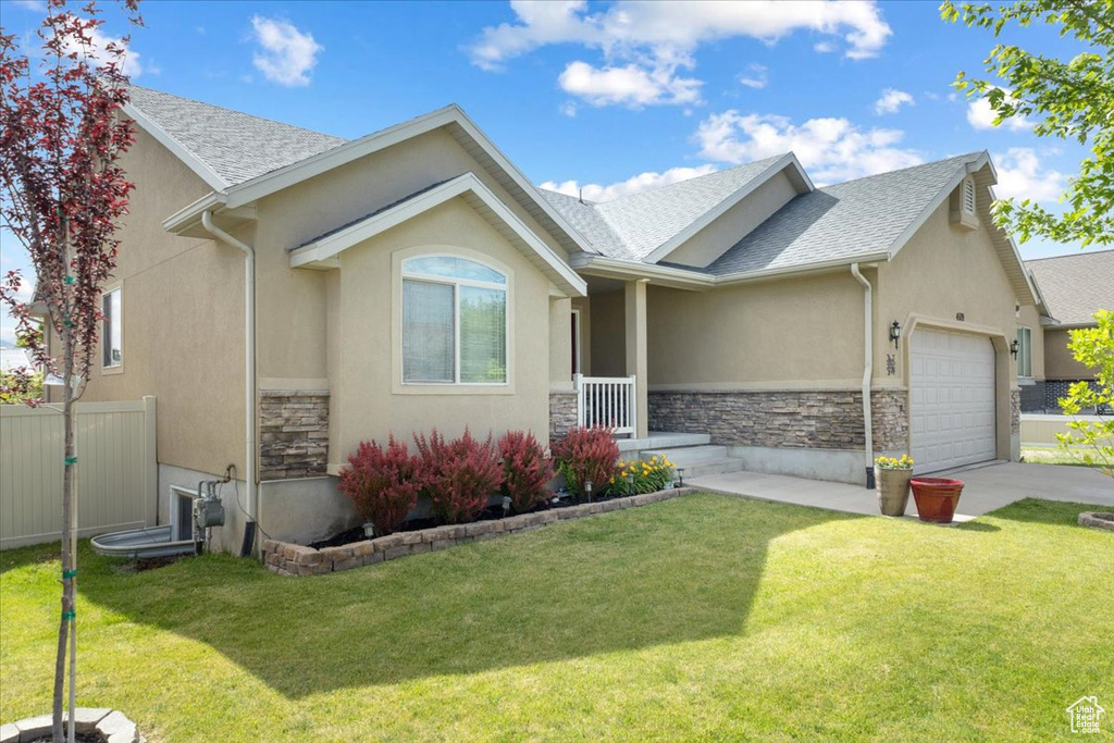 Single story home with an attached garage, stone siding, stucco siding, roof with shingles, and concrete driveway