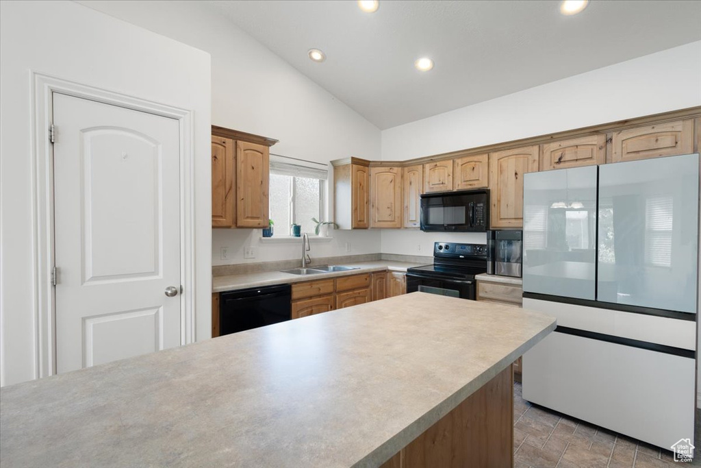 Kitchen featuring black appliances, recessed lighting, light countertops, and high vaulted ceiling