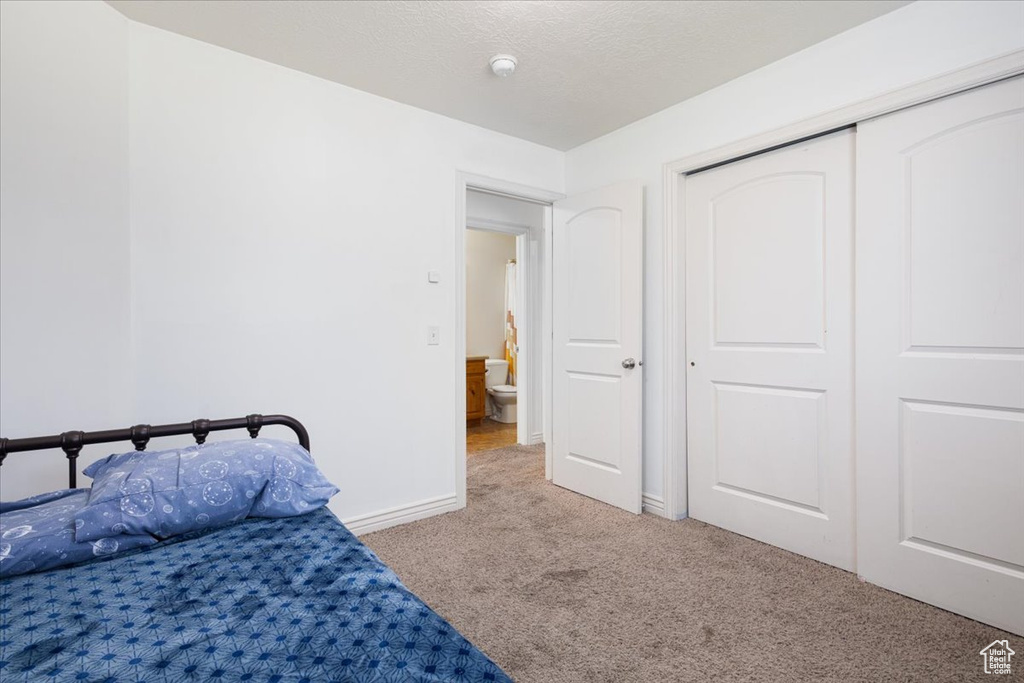 Bedroom with carpet flooring and a closet