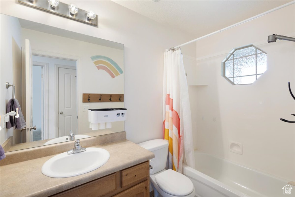 Full bathroom with vanity and shower / bath combo with shower curtain