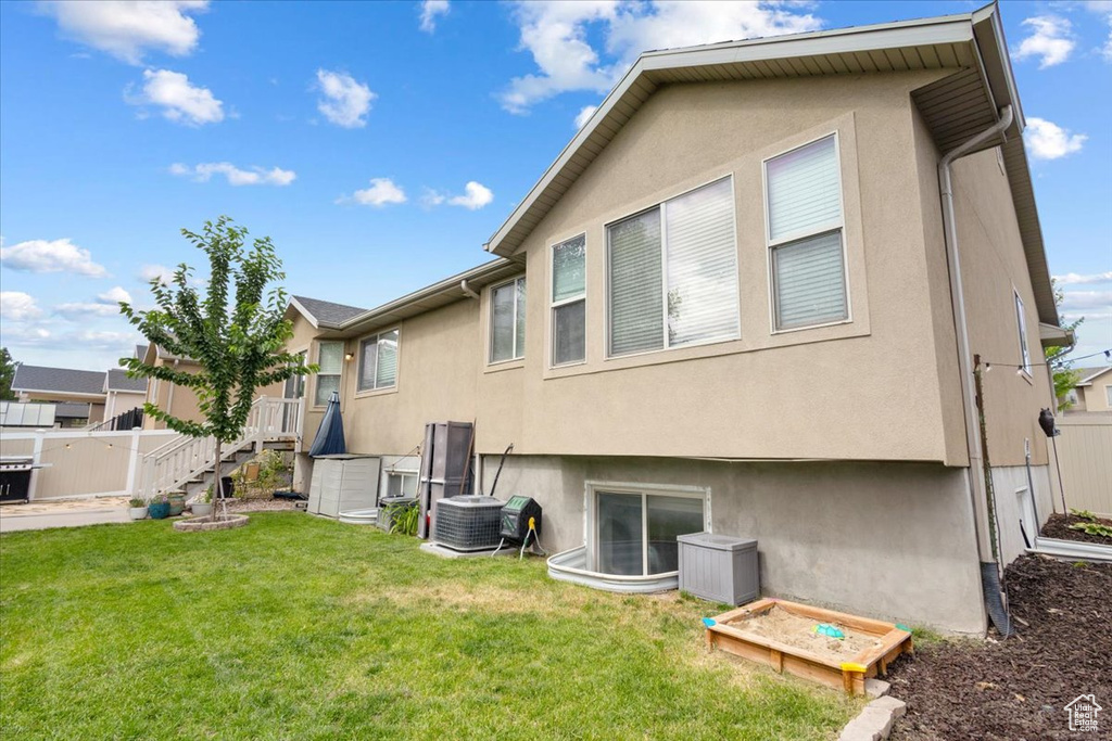 Back of property featuring stucco siding