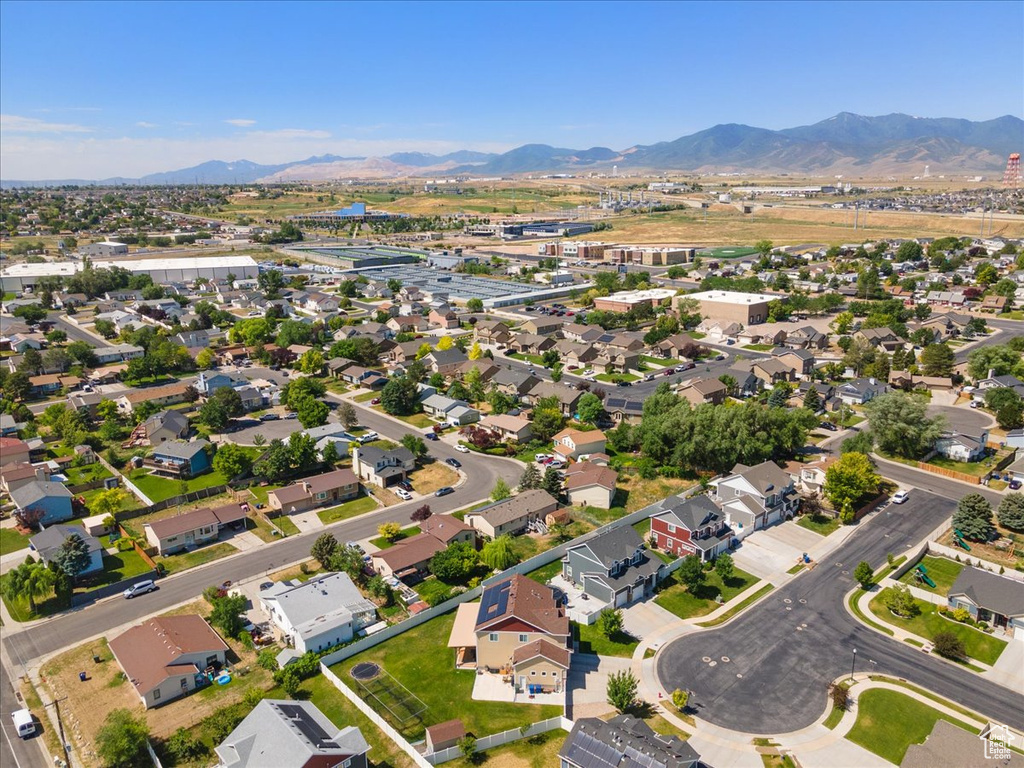 Aerial overview of property\'s location with a mountain backdrop and nearby suburban area