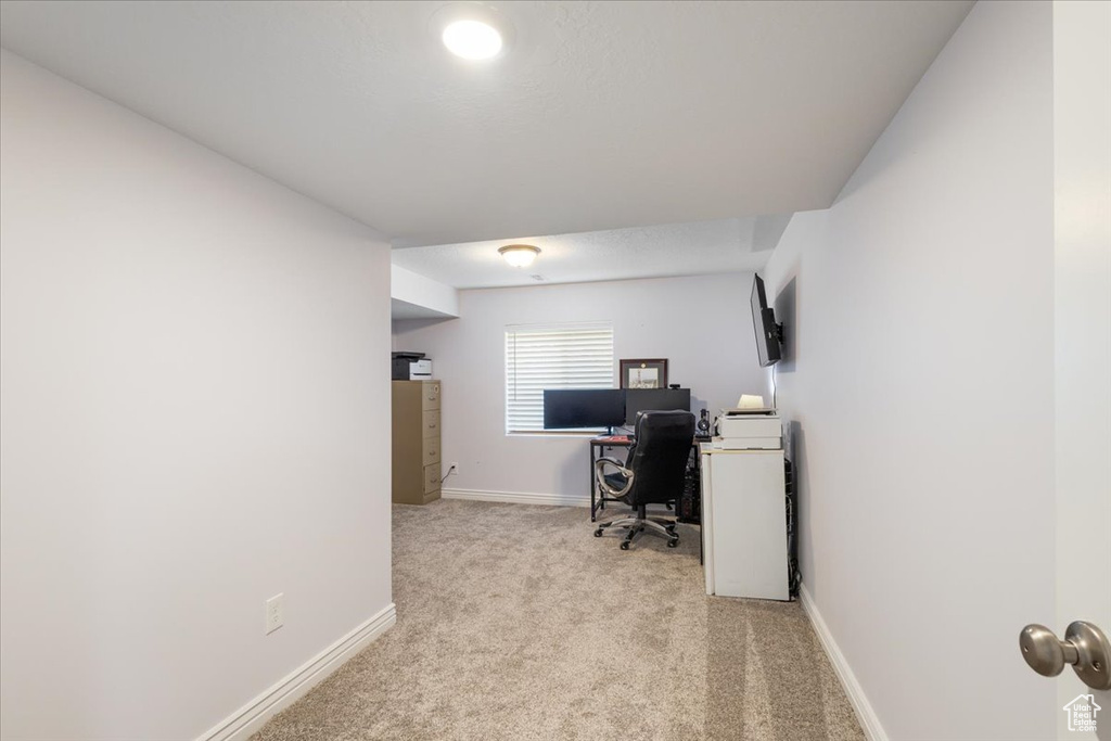Carpeted office space featuring baseboards