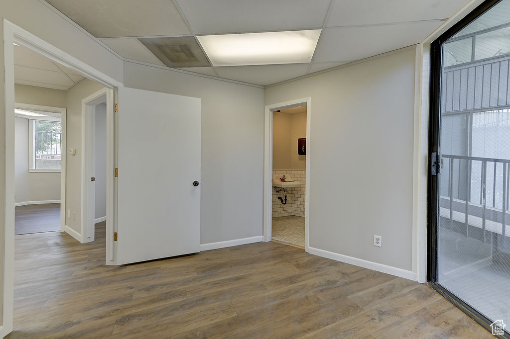 Unfurnished bedroom featuring wood finished floors and connected bathroom