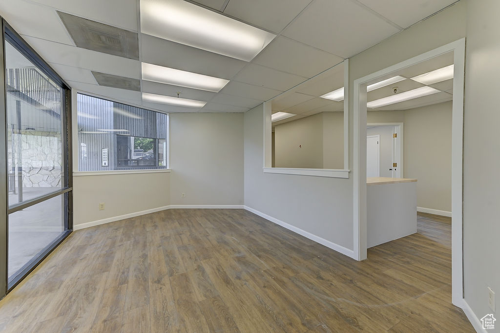 Spare room featuring wood finished floors and a paneled ceiling